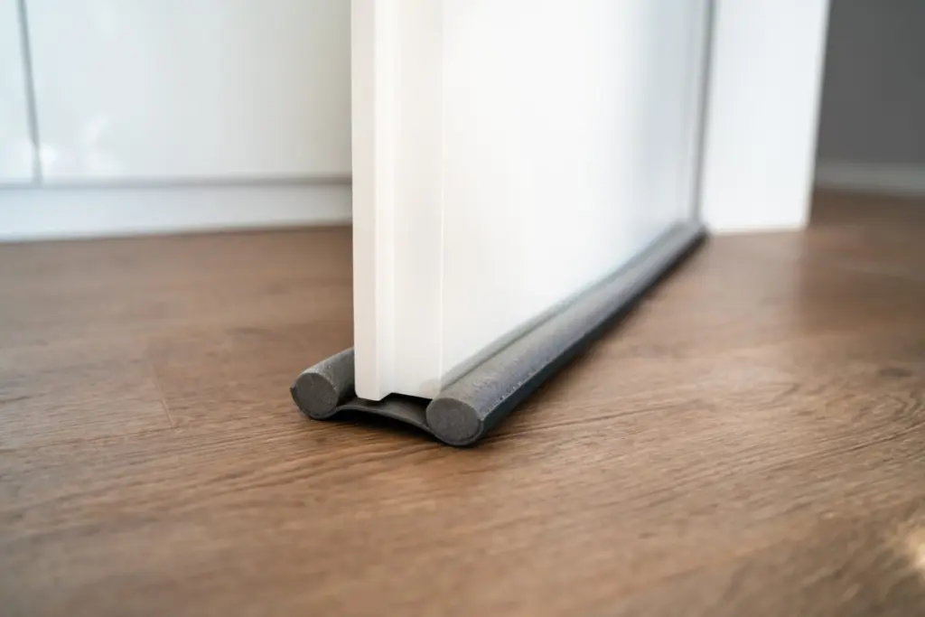 stock-photo-door-draft-stopper-or-excluder-stop-cold-air-2070184271
