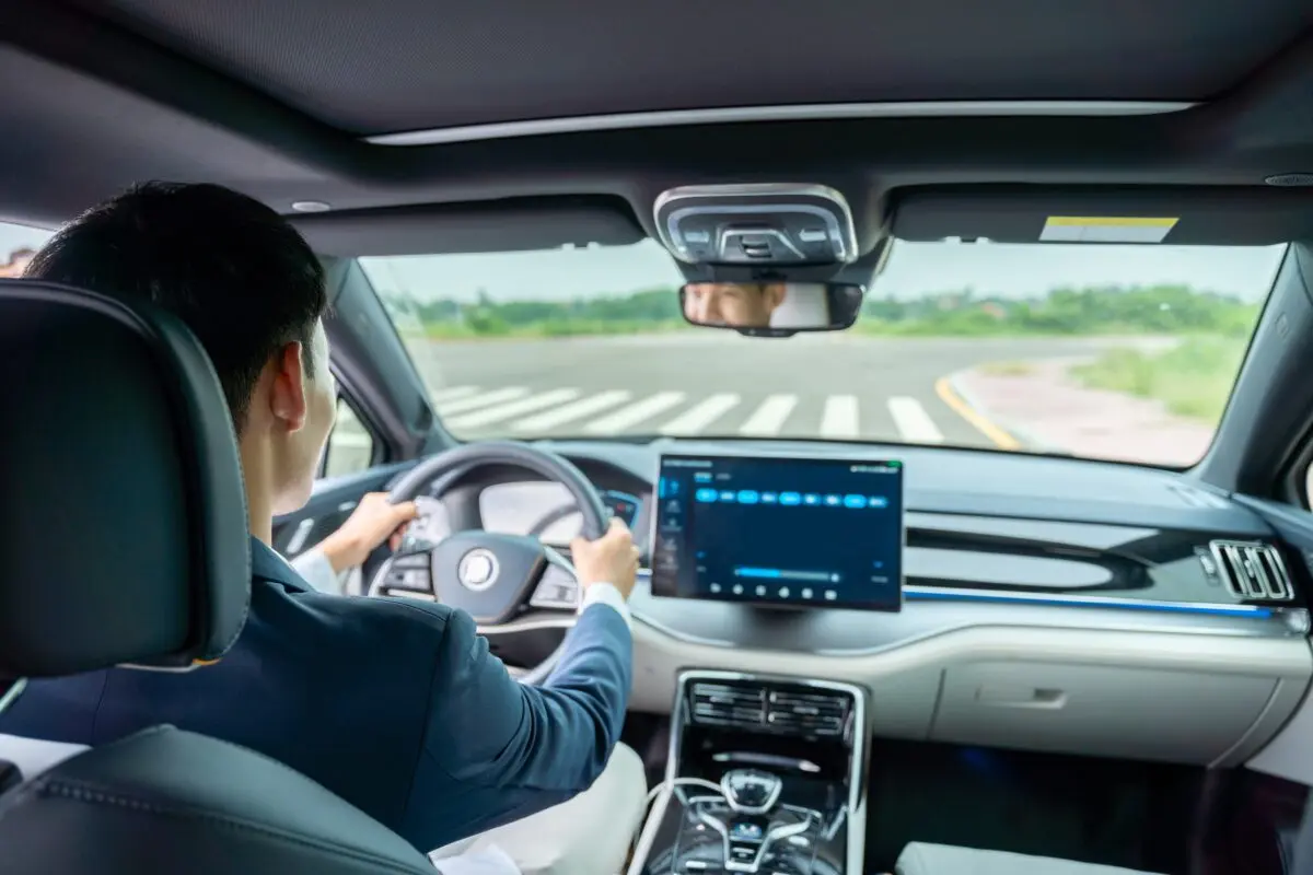 stock-photo-a-man-driving-inside-of-electric-car-front-view-of-the-road-electric-car-ev-car-ev-vehicle-2203990117