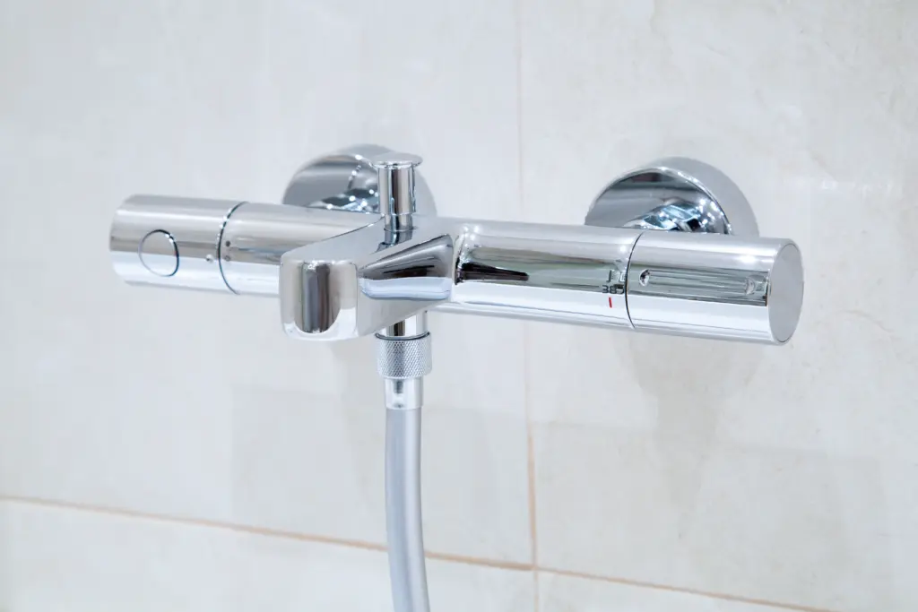 stock-photo-a-new-modern-thermostatic-shower-faucet-on-the-wall-in-bathroom-347028434