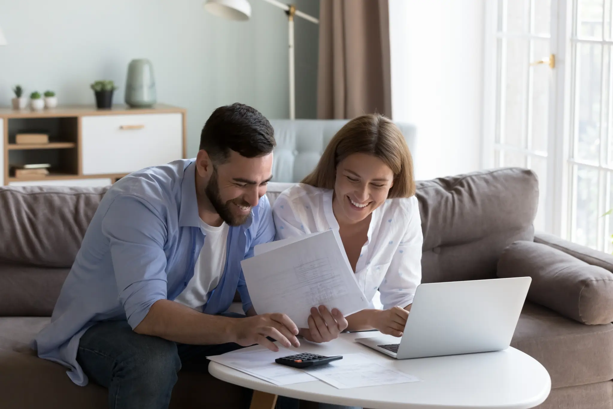 stock-photo-cheerful-young-millennial-husband-and-wife-doing-domestic-paperwork-accounting-job-reviewing-2203225387
