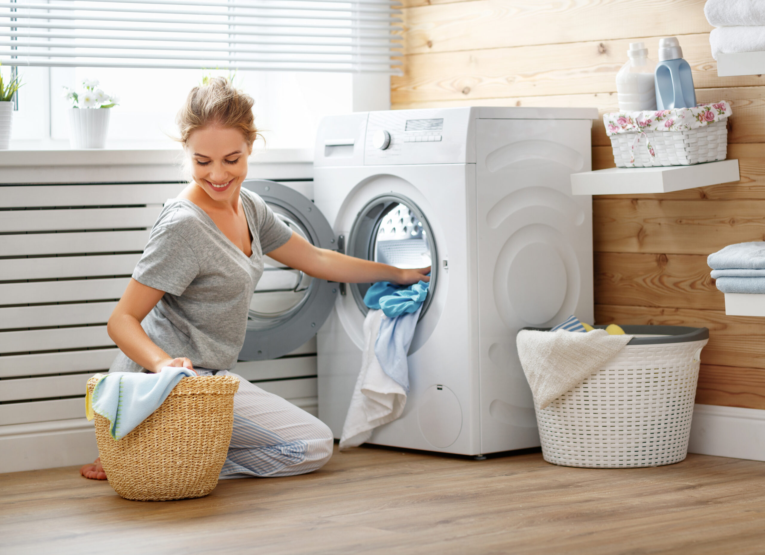 stock-photo-a-happy-housewife-woman-in-laundry-room-with-washing-machine-793737499
